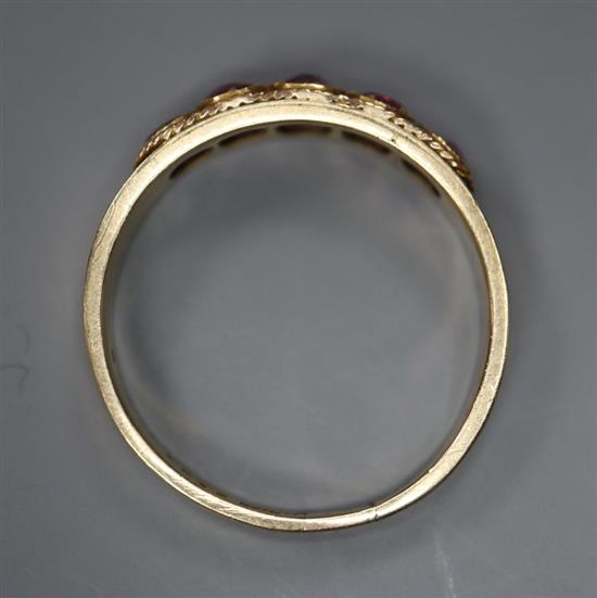 An early 20th century 10ct yellow metal and graduated five stone garnet set half hoop ring, size R, gross 1.9 grams.